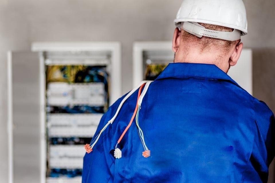 A technician working methodically at a control panel, the same procedural precision a practice expects from a collection partner