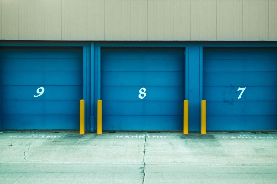 Numbered loading dock bays at a distribution facility, the kind of covered workforce a random testing pool is drawn from